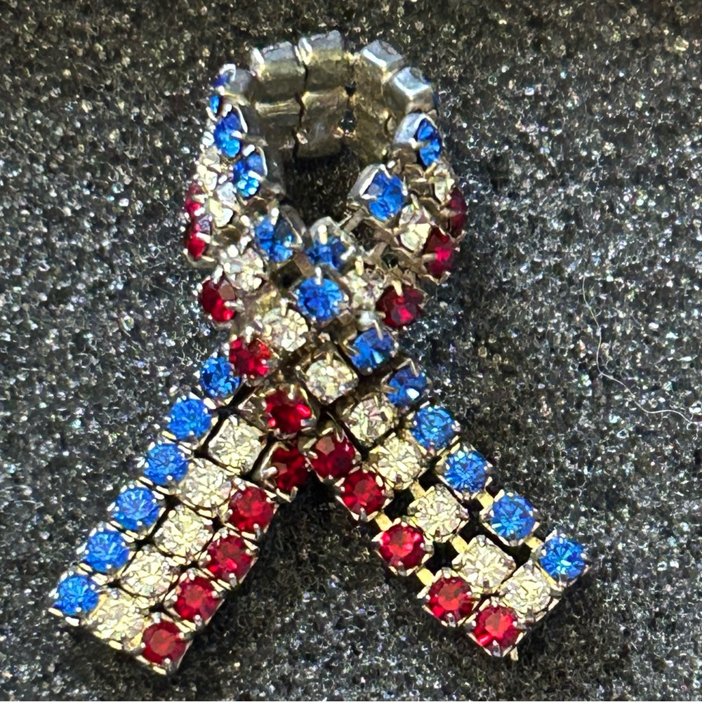 Vintage red white and blue rhinestone ribbon pin. Approx 1 and 1/2 inch long